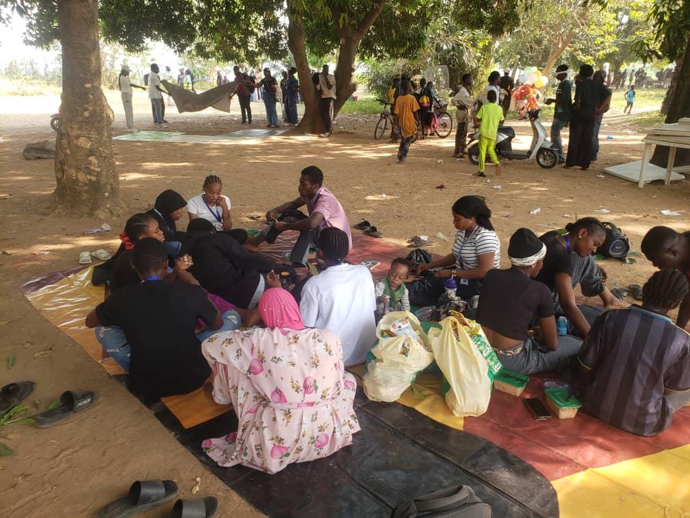 MMCAAT students relaxing and socializing outdoors during a tour picnic