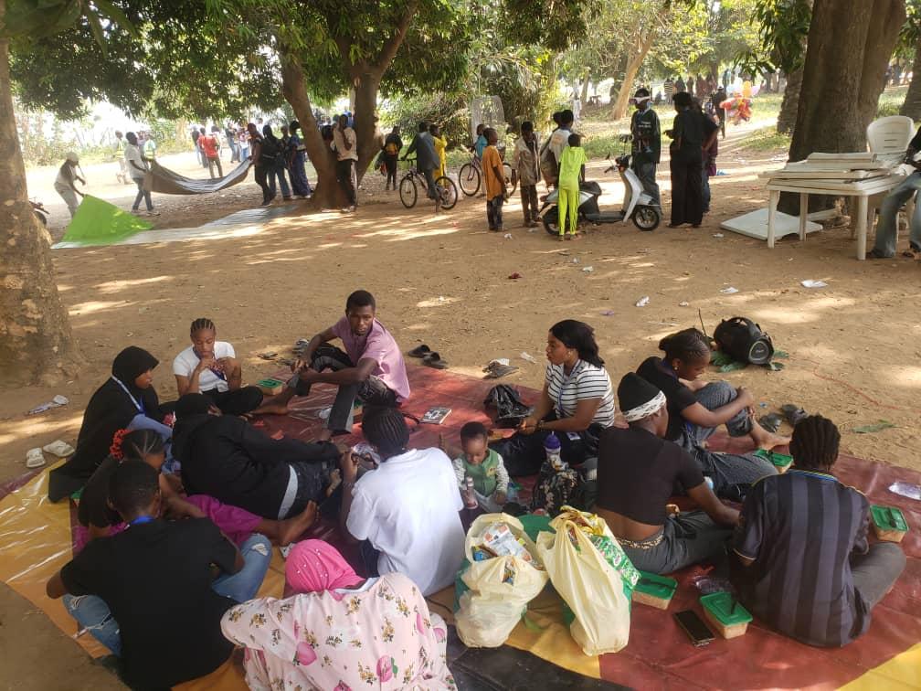MMCAAT students seated together outdoors during a tour picnic